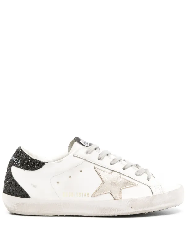 Golden Goose Super-Star trainers with gold star and black glitter heels tab