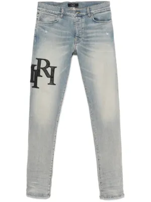 AMIRI staggered logo skinny jeans - black red